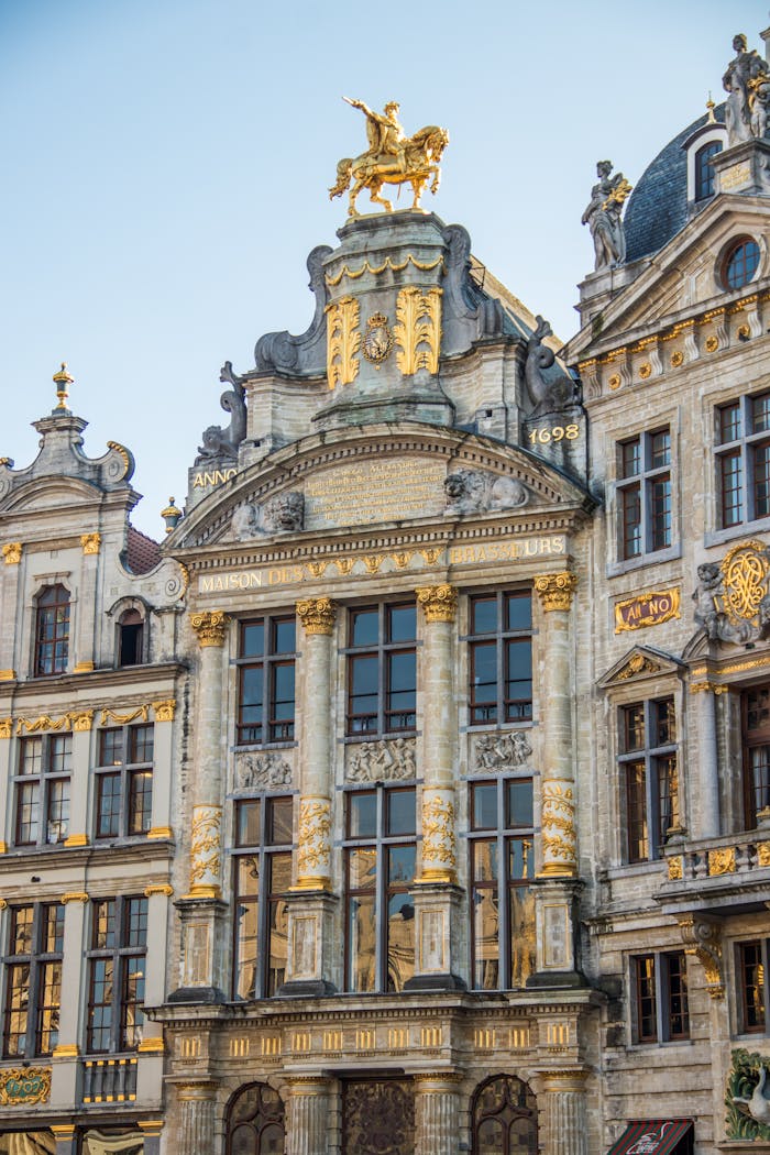 Stunning architectural detail of Brussels' Grand Place featuring ornate facades and golden statues.